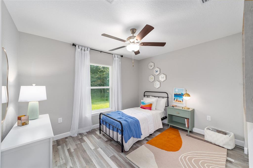 8571 Southwest 131st Place Ocala, FL 34473 - Photo 27 of 32 a bedroom with a bed dresser and a window