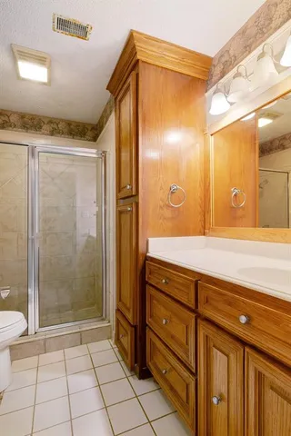 a bathroom with a shower and a sink