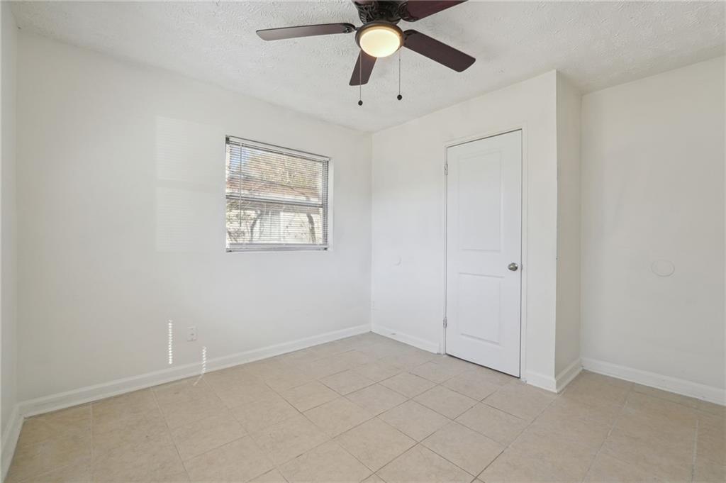 324 Brooks Avenue Southwest, Unit B Atlanta, GA 30310 - Photo 13 of 25 an empty room with fan and windows
