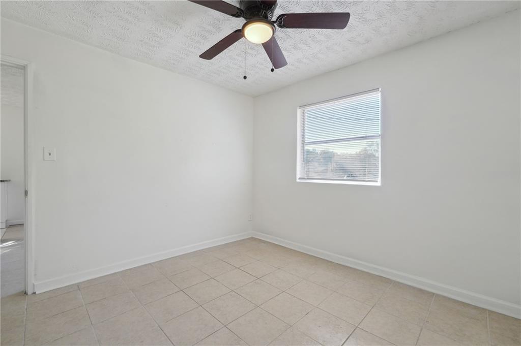 324 Brooks Avenue Southwest, Unit B Atlanta, GA 30310 - Photo 15 of 25 an empty room with a window and a fan