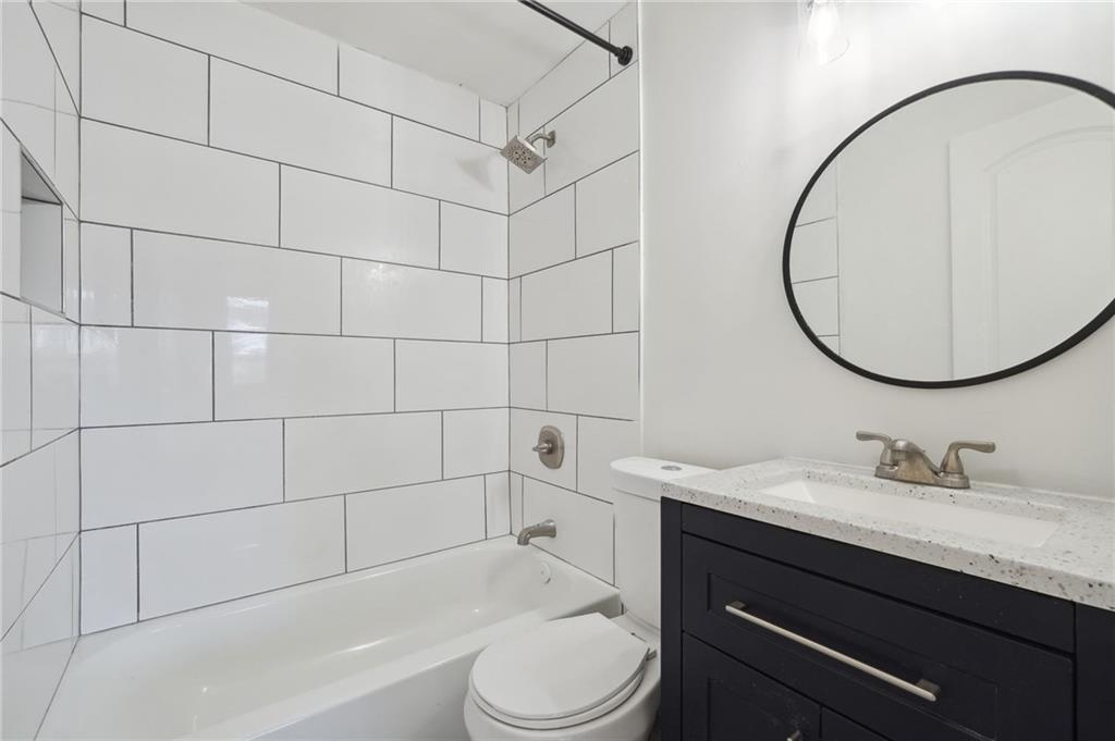 324 Brooks Avenue Southwest, Unit B Atlanta, GA 30310 - Photo 20 of 25 a bathroom with a sink a toilet and a mirror