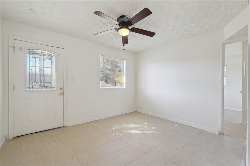 324 Brooks Avenue Southwest, Unit B Atlanta, GA 30310 - Photo 6 of 25 a view of an empty room with a ceiling fan and window