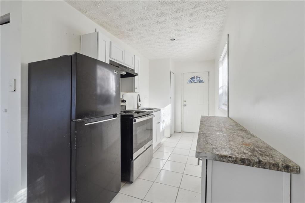 324 Brooks Avenue Southwest, Unit B Atlanta, GA 30310 - Photo 8 of 25 a kitchen with granite countertop a refrigerator and a sink