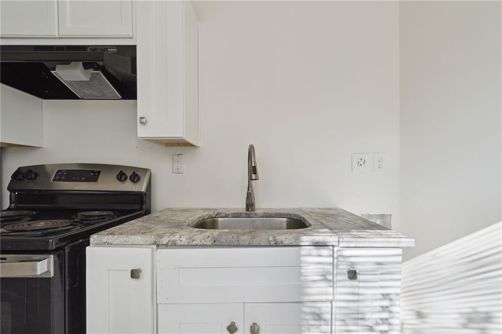324 Brooks Avenue Southwest, Unit B Atlanta, GA 30310 - Photo 10 of 25 a kitchen with a stove and cabinets