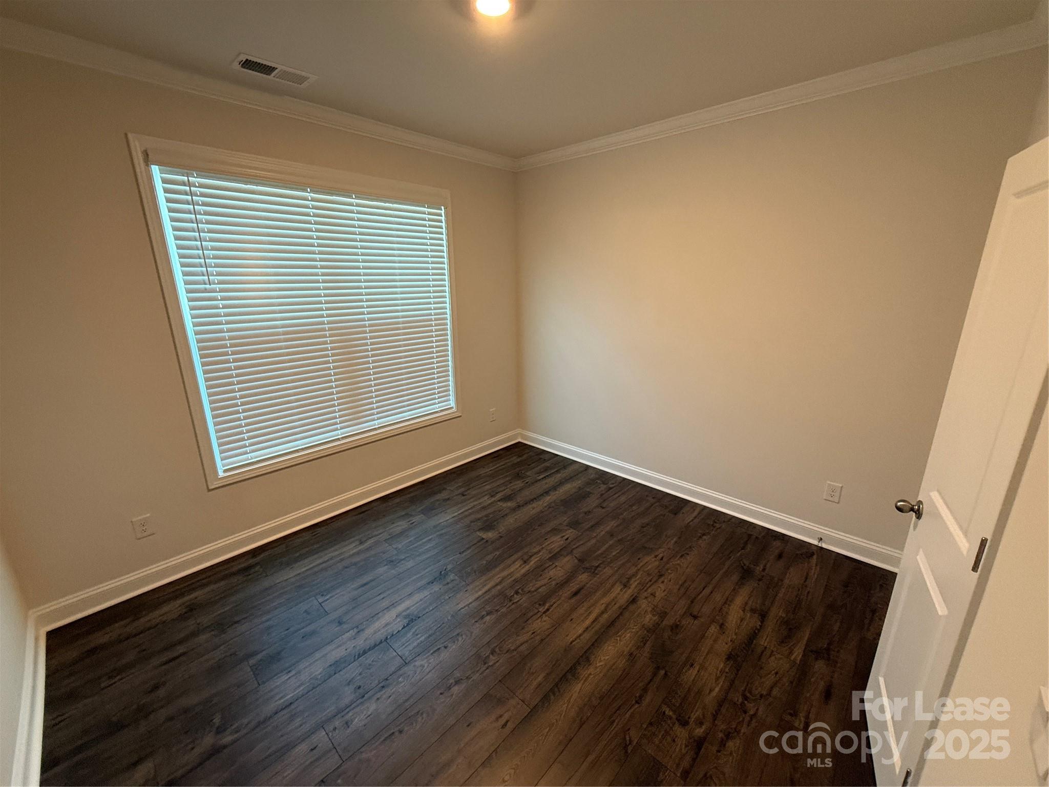 4144 Steel Way Sherrills Ford, NC 28673 - Photo 11 of 24 a view of an empty room with wooden floor and a window