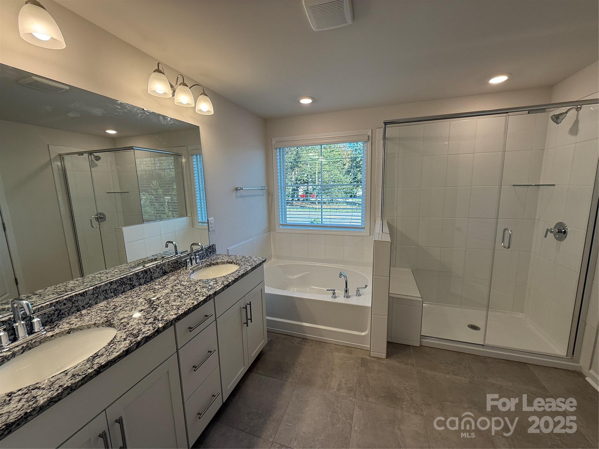 4144 Steel Way Sherrills Ford, NC 28673 - Photo 18 of 24 a bathroom with a granite countertop sink a mirror and a bathtub