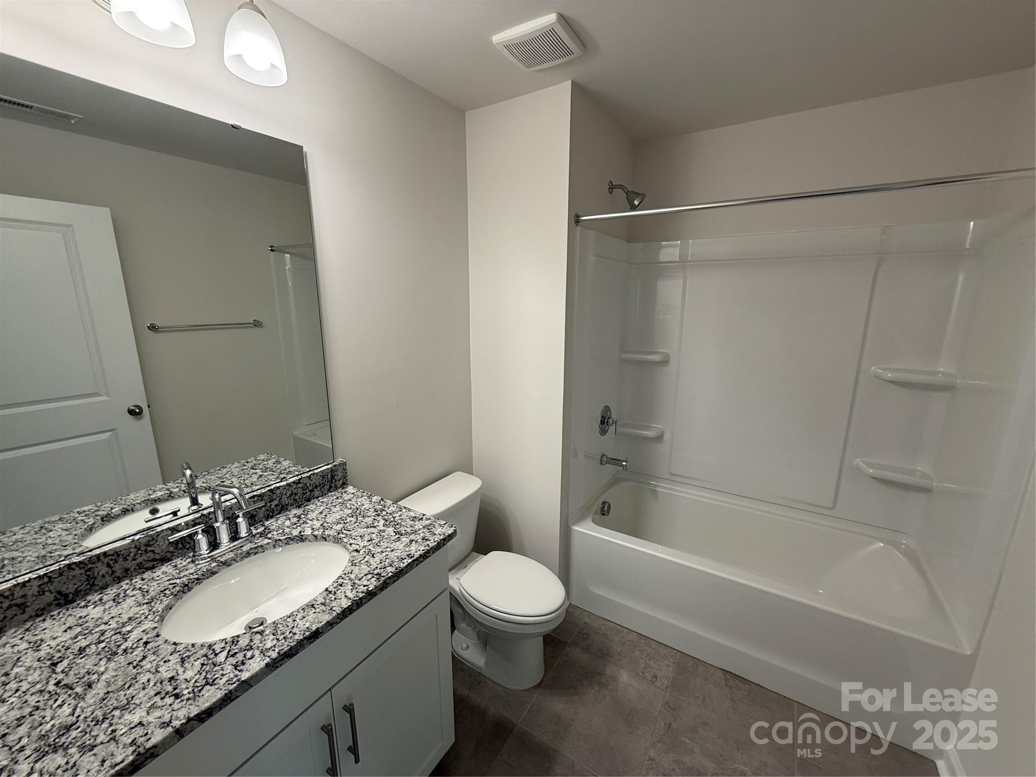 4144 Steel Way Sherrills Ford, NC 28673 - Photo 21 of 24 a bathroom with a granite countertop sink toilet tub and shower