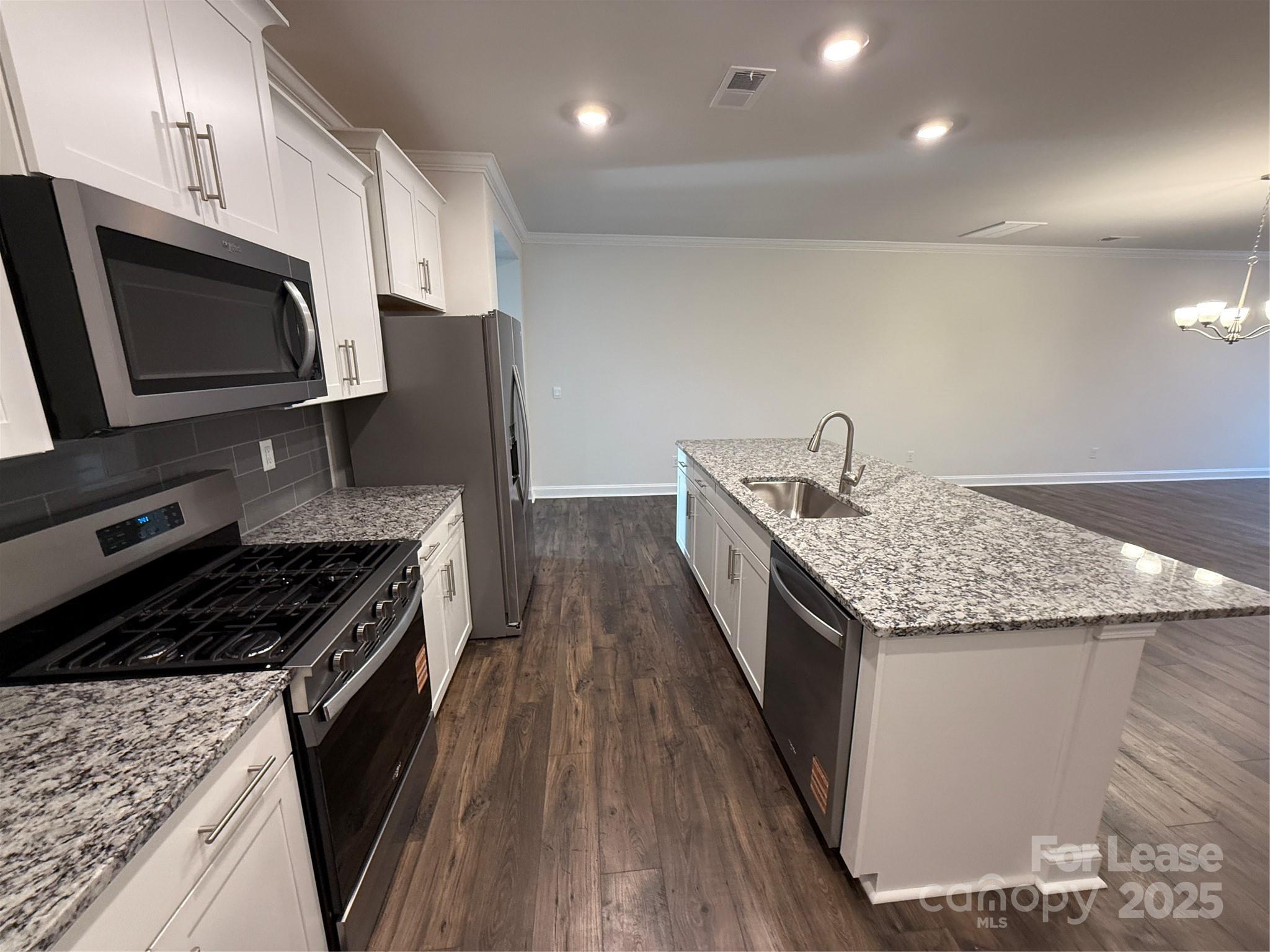 4144 Steel Way Sherrills Ford, NC 28673 - Photo 6 of 24 a kitchen with granite countertop stainless steel appliances and wooden cabinets