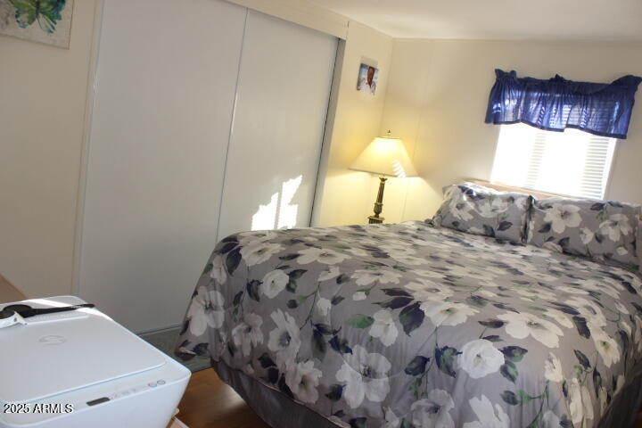 303 South Recker Road, Unit 223 Mesa, AZ 85206 - Photo 16 of 31 a bedroom with a bed and a lamp with window