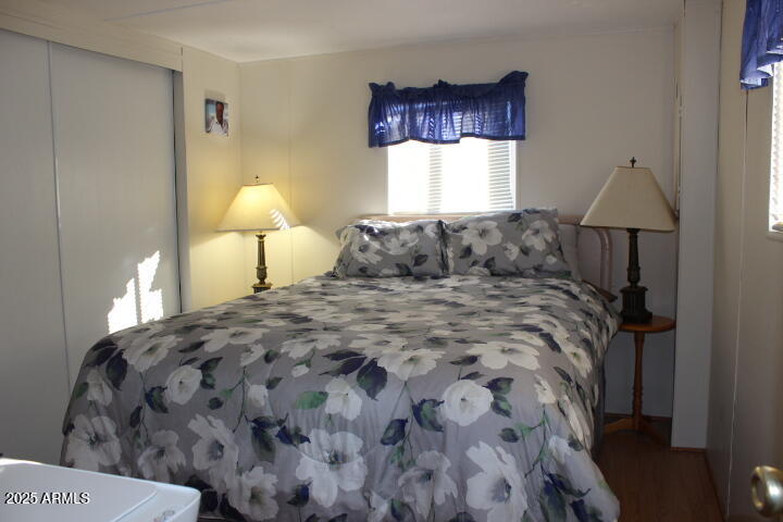 303 South Recker Road, Unit 223 Mesa, AZ 85206 - Photo 17 of 31 a bedroom with a bed and a lamp on table
