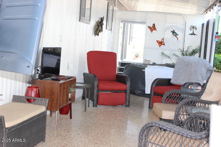 303 South Recker Road, Unit 223 Mesa, AZ 85206 - Photo 25 of 31 a living room with furniture and a mirror