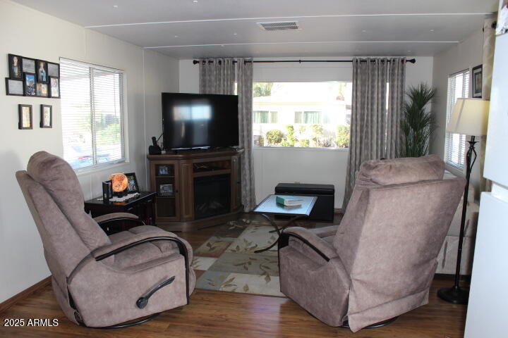 303 South Recker Road, Unit 223 Mesa, AZ 85206 - Photo 4 of 31 a living room with furniture and a flat screen tv