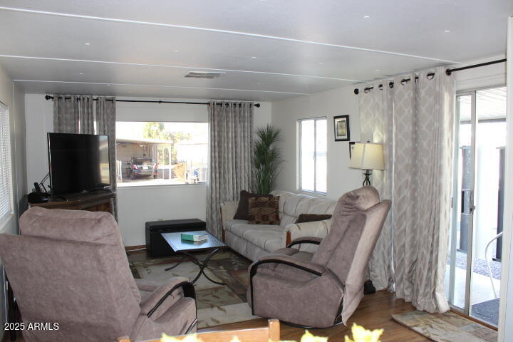303 South Recker Road, Unit 223 Mesa, AZ 85206 - Photo 5 of 31 a living room with furniture and a flat screen tv