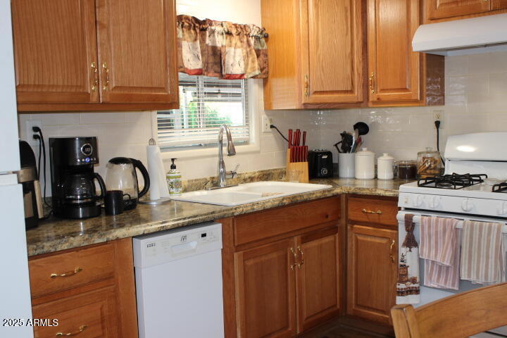 303 South Recker Road, Unit 223 Mesa, AZ 85206 - Photo 8 of 31 a kitchen with granite countertop a sink and cabinets