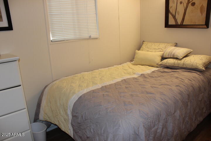 303 South Recker Road, Unit 223 Mesa, AZ 85206 - Photo 10 of 31 a bed sitting in a bedroom next to a window