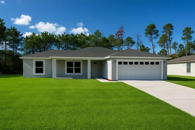 a view of a house with a yard and potted plants