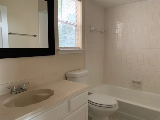 a bathroom with a sink a toilet and a bathtub