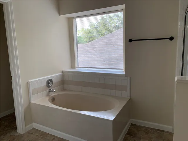 a white bath tub sitting next to a window