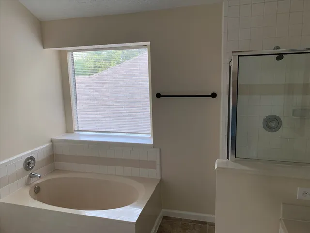 a bathroom with a tub and shower