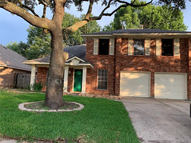 a front view of house with a garden