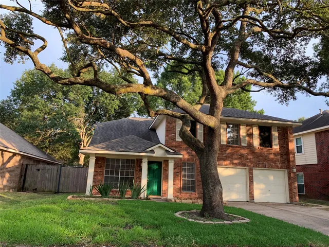 a front view of house with a garden