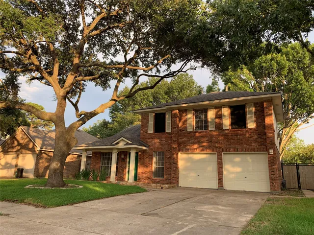 front view of house with a tree