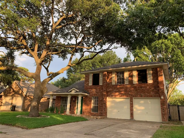 front view of house with a tree