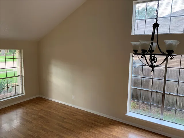 a view of workspace with wooden floor and windows