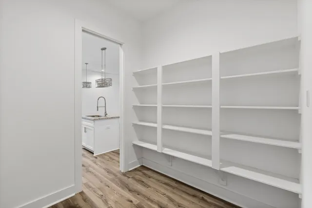 a view of kitchen with stainless steel appliances refrigerator stove microwave and cabinets