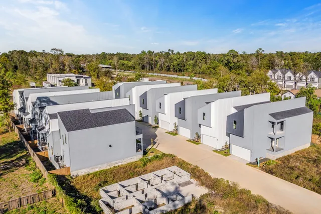 an aerial view of residential houses with outdoor space