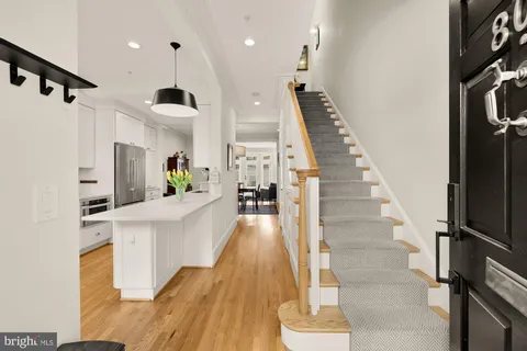 a view of entryway and hall with wooden floor