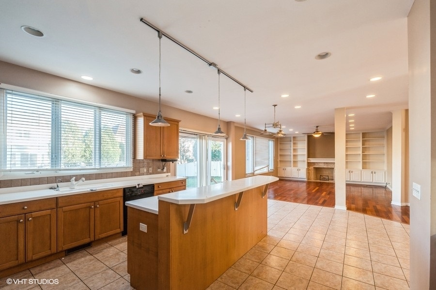 2021 Wright Boulevard Buffalo Grove, IL 60089 - Photo 12 of 29 a large kitchen with kitchen island a large counter top space a sink stainless steel appliances and cabinets