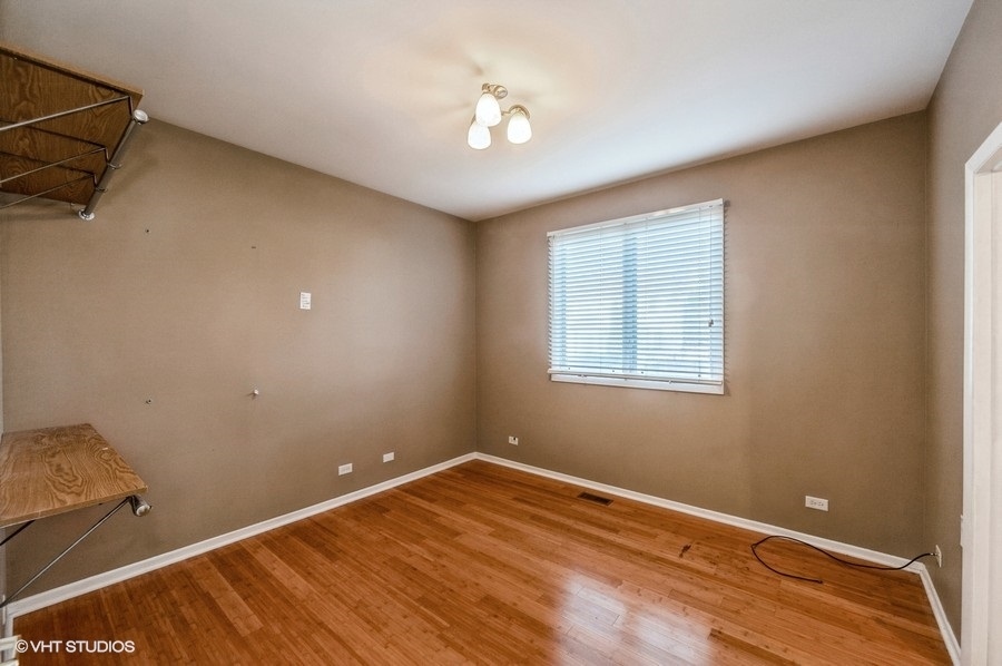 2021 Wright Boulevard Buffalo Grove, IL 60089 - Photo 13 of 29 a view of a room with wooden floor and fan