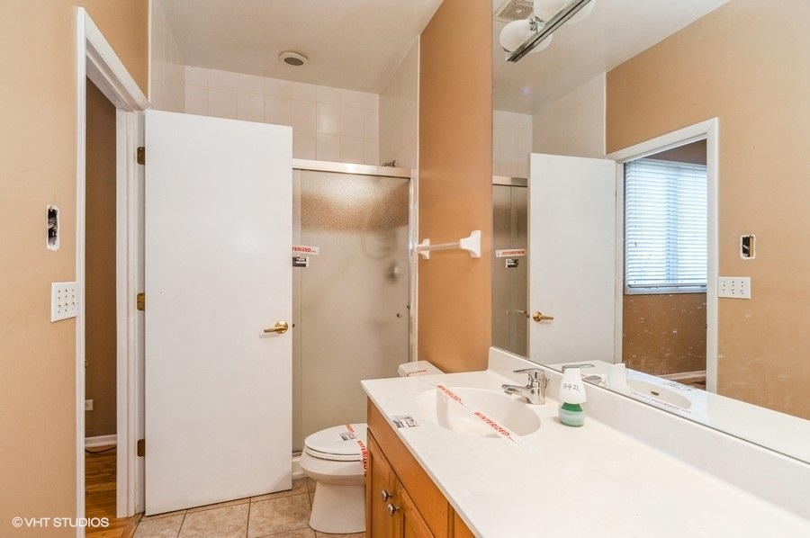 2021 Wright Boulevard Buffalo Grove, IL 60089 - Photo 14 of 29 a bathroom with a sink a toilet and shower