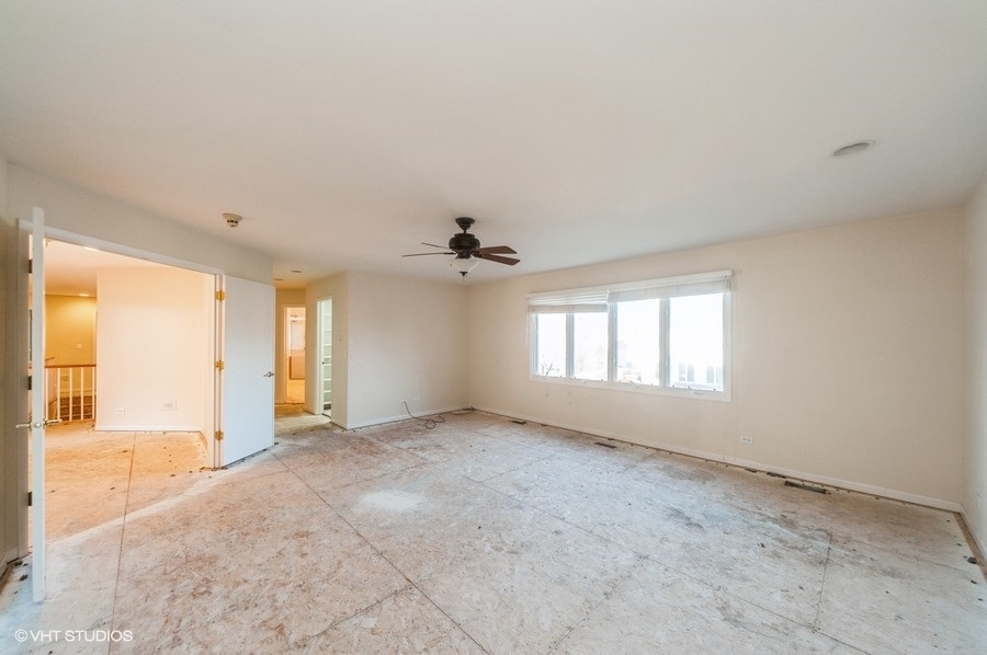 2021 Wright Boulevard Buffalo Grove, IL 60089 - Photo 16 of 29 an empty room with windows and a ceiling fan