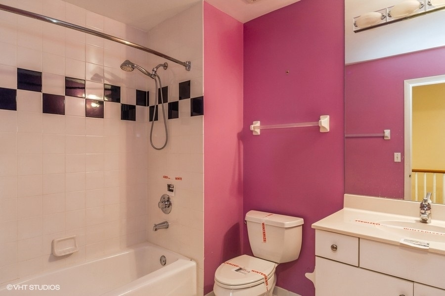 2021 Wright Boulevard Buffalo Grove, IL 60089 - Photo 19 of 29 a bathroom with a sink a toilet a mirror and shower