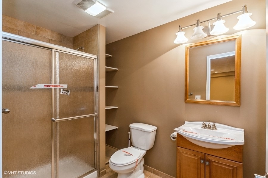 2021 Wright Boulevard Buffalo Grove, IL 60089 - Photo 26 of 29 a bathroom with a toilet sink shower and mirror