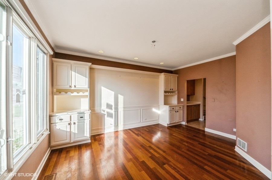 2021 Wright Boulevard Buffalo Grove, IL 60089 - Photo 5 of 29 a view of an empty room with a window and wooden floor