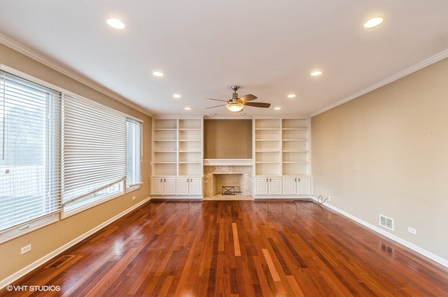 2021 Wright Boulevard Buffalo Grove, IL 60089 - Photo 9 of 29 a view of empty room with wooden floor and fireplace