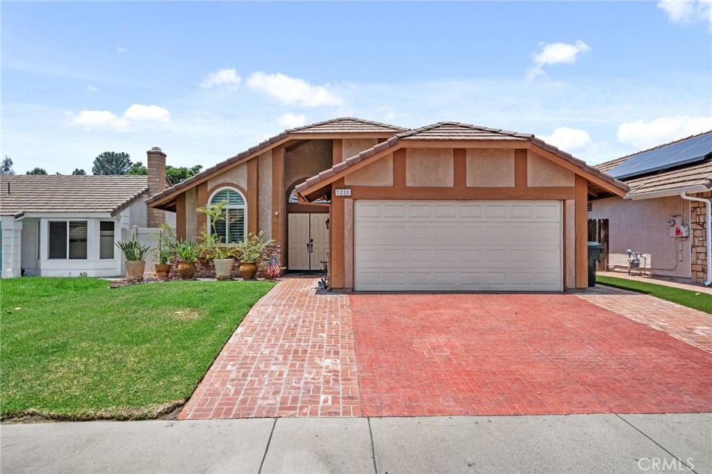 7210 Travis Place Rancho Cucamonga, CA 91739 - Photo 1 of 1 a front view of a house with a yard and garage