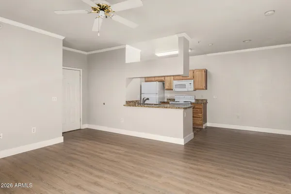 a view of kitchen with wooden floor and electronic appliances