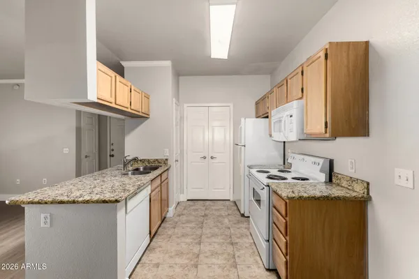 a kitchen with stainless steel appliances granite countertop a sink stove and cabinets
