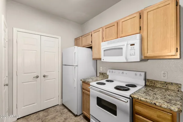 a white stove top oven sitting inside of a kitchen