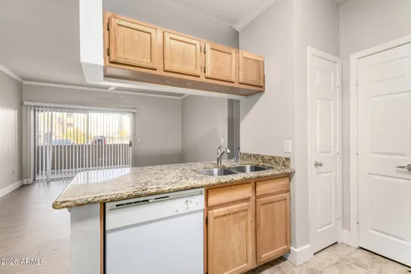 a kitchen with granite countertop a sink and cabinets