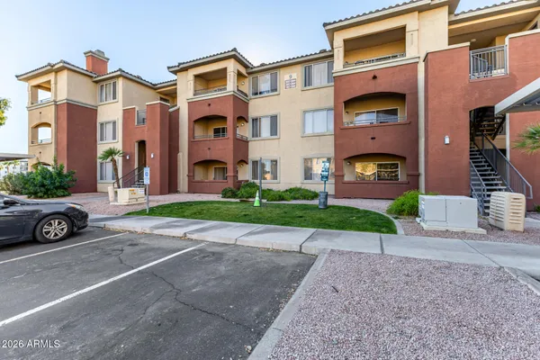 a view of a street with a cars parked in front of it