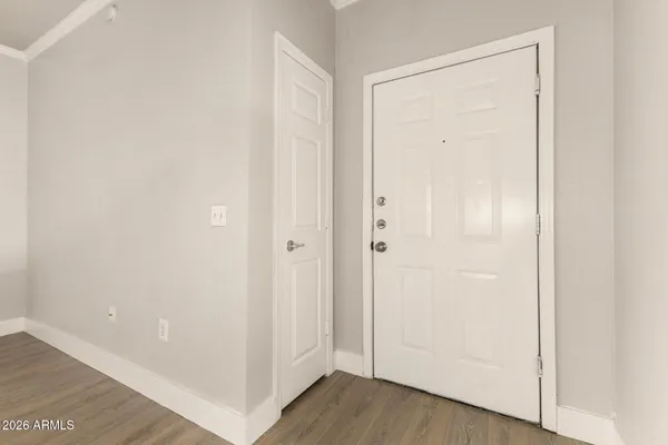 a view of a hallway with wooden floor