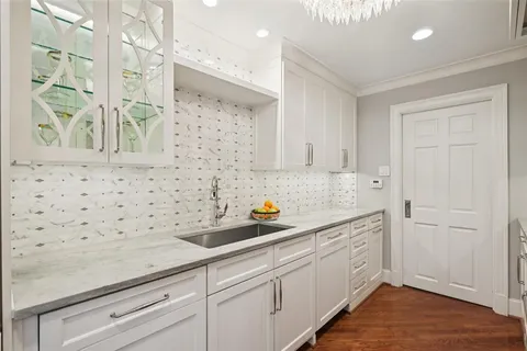 a kitchen with a sink a stove and cabinets