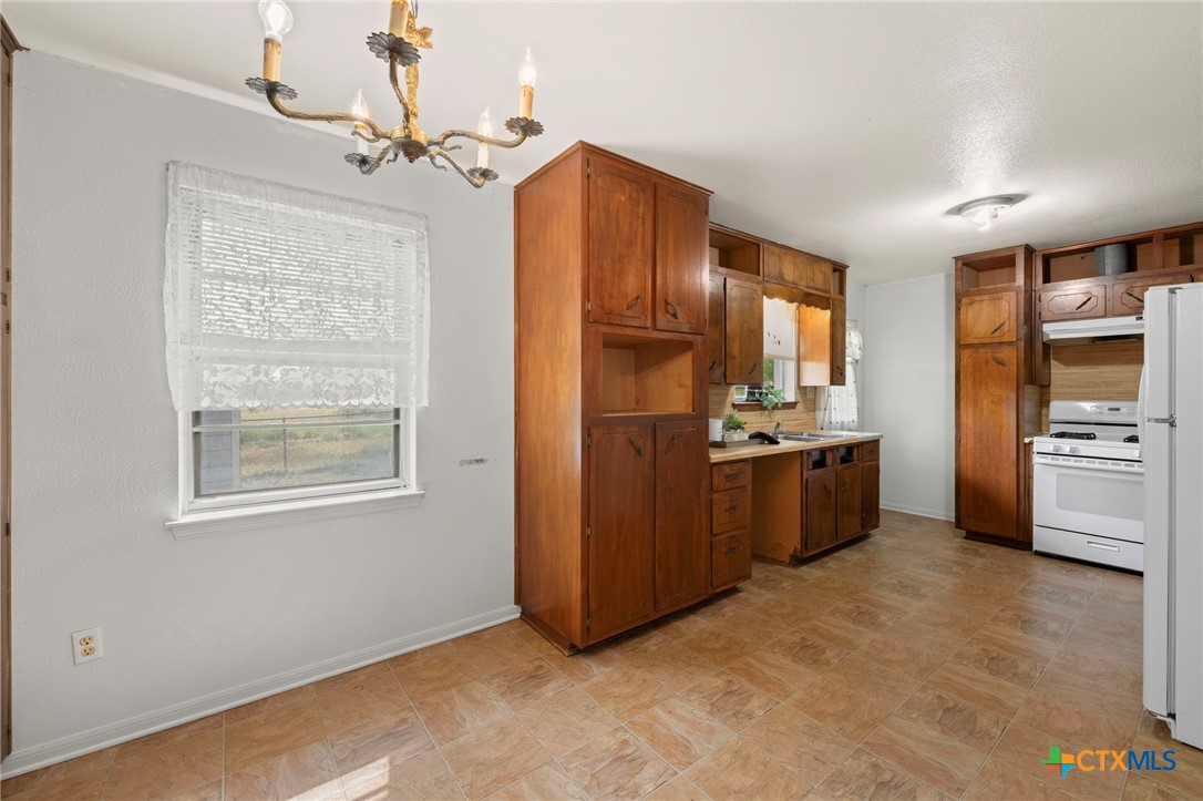23168 Wolfridge Road Killeen, TX 76549 - Photo 14 of 42 a kitchen with stainless steel appliances a refrigerator and a stove top oven