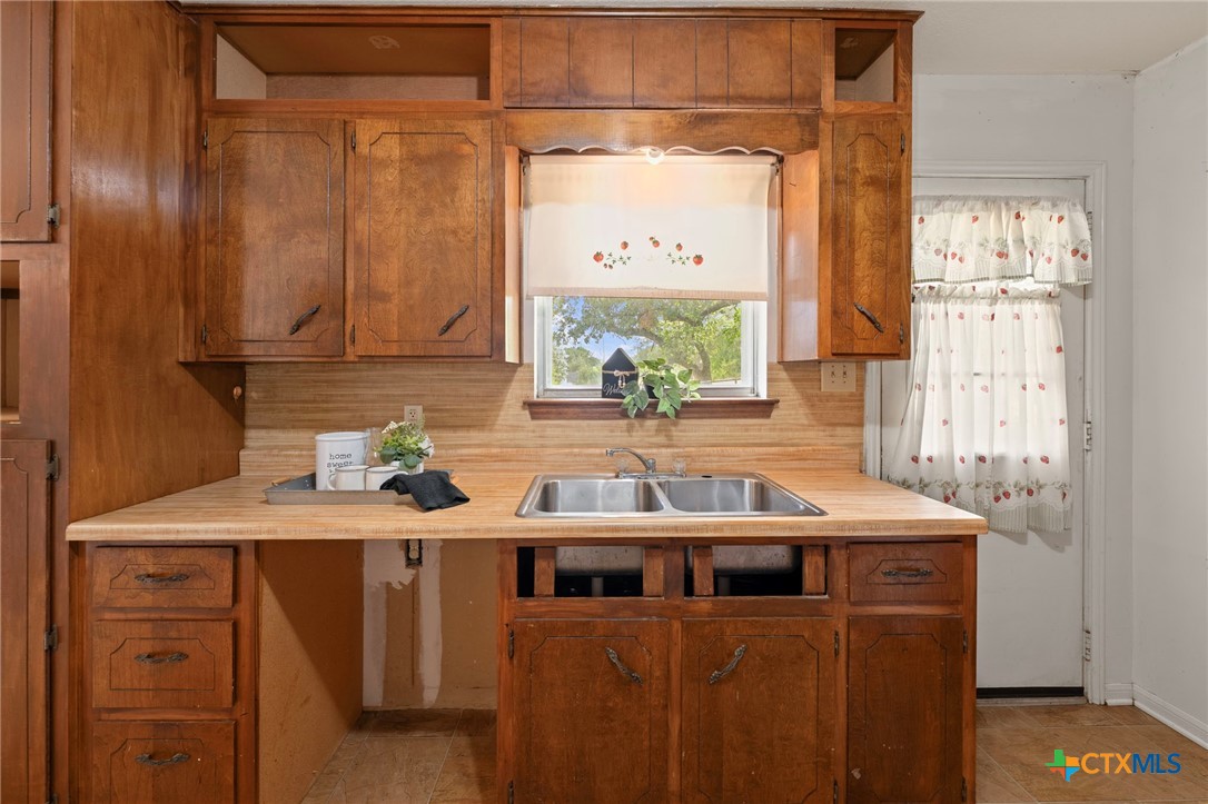 23168 Wolfridge Road Killeen, TX 76549 - Photo 17 of 42 a kitchen with a sink a window and cabinets