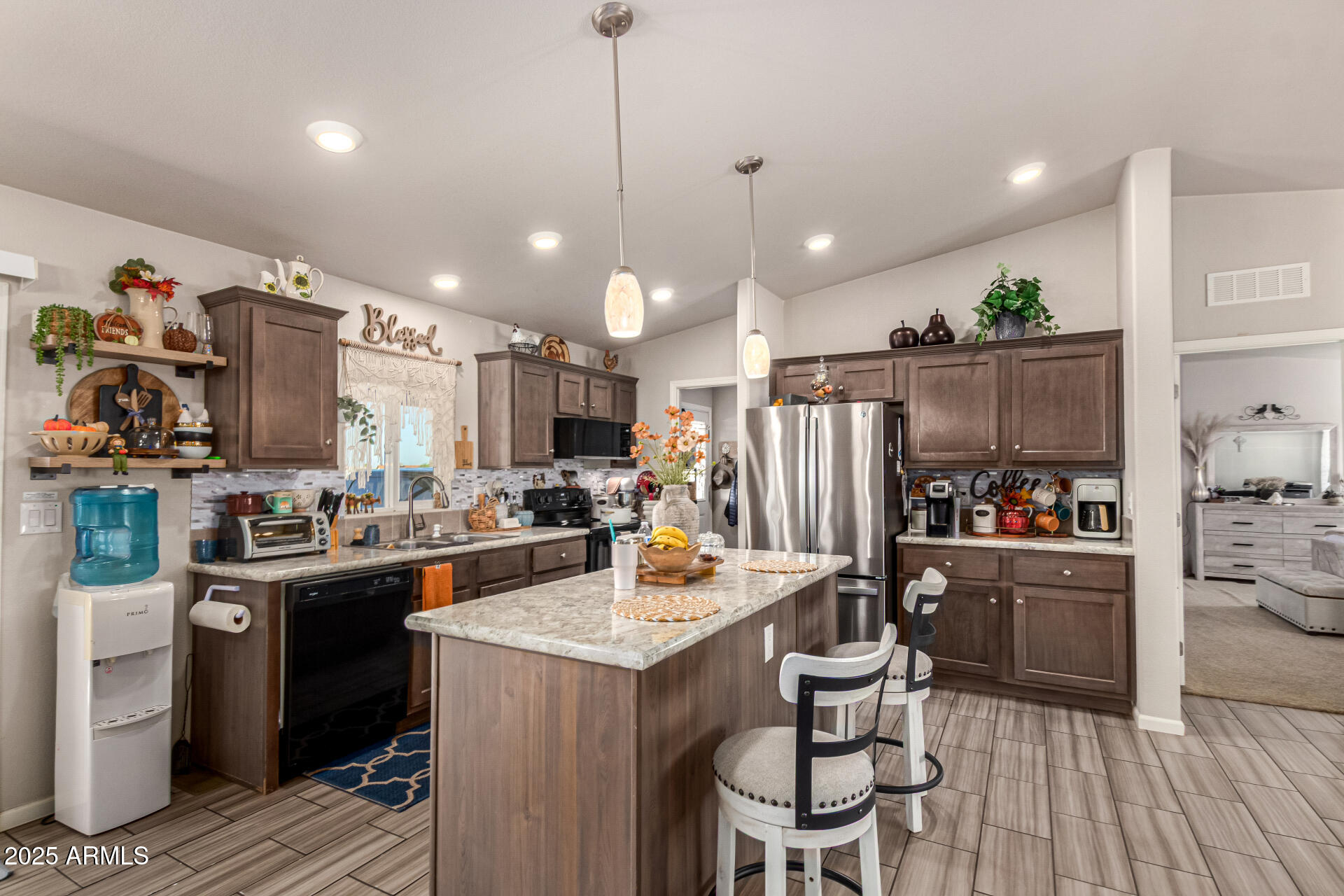 20514 West Narramore Road Buckeye, AZ 85326 - Photo 11 of 31 a kitchen with refrigerator and chairs